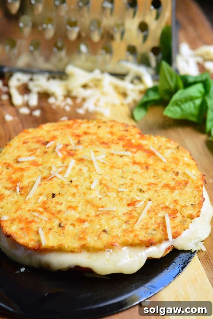 Cauliflower grilled cheese mozzarella and cheddar on a cutting board with a cheese grater 