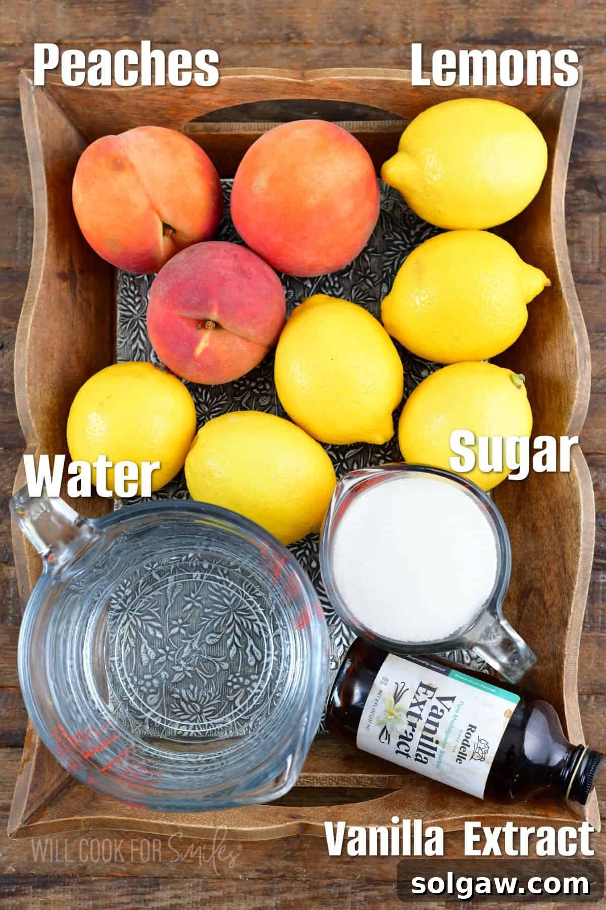 Carefully arranged ingredients for crafting the perfect peach lemonade, featuring vibrant lemons and ripe peaches on a rustic wooden tray.