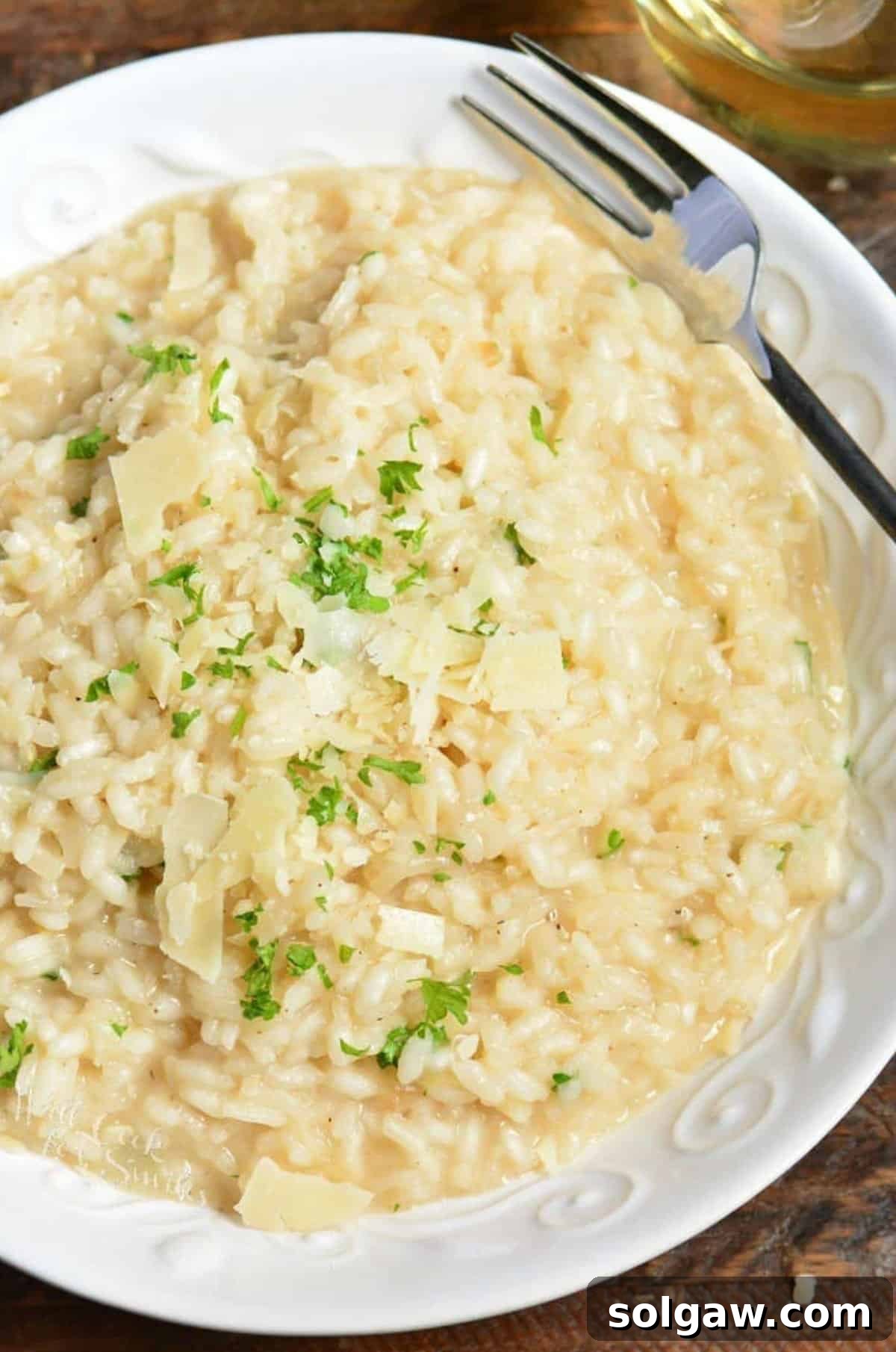 Creamy Grana Rice 8 A bowl of creamy Parmesan Risotto with a fork resting on the side.