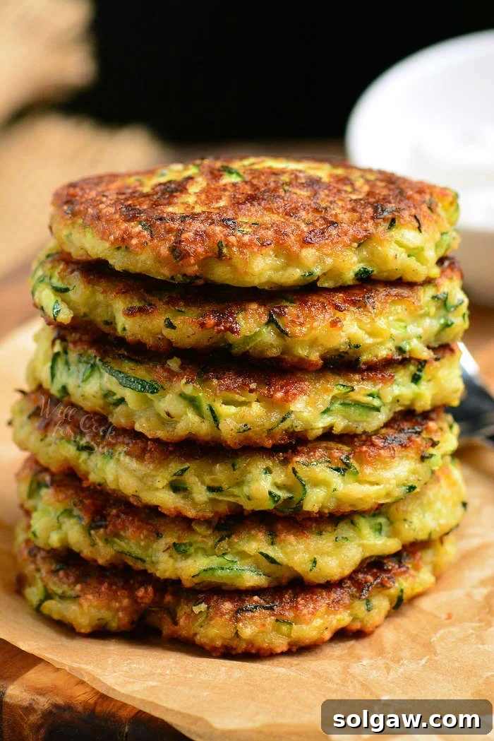 Zucchini Fritters stacked on a plate