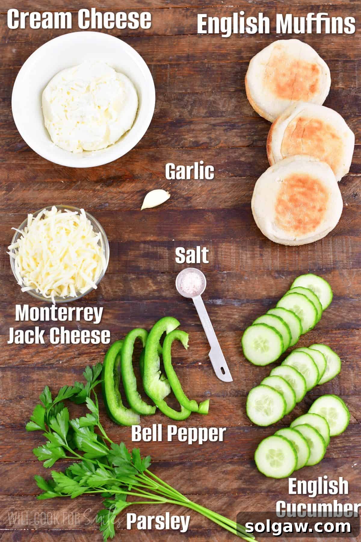 Labeled ingredients for shamrock cucumber sandwiches on a wood surface.