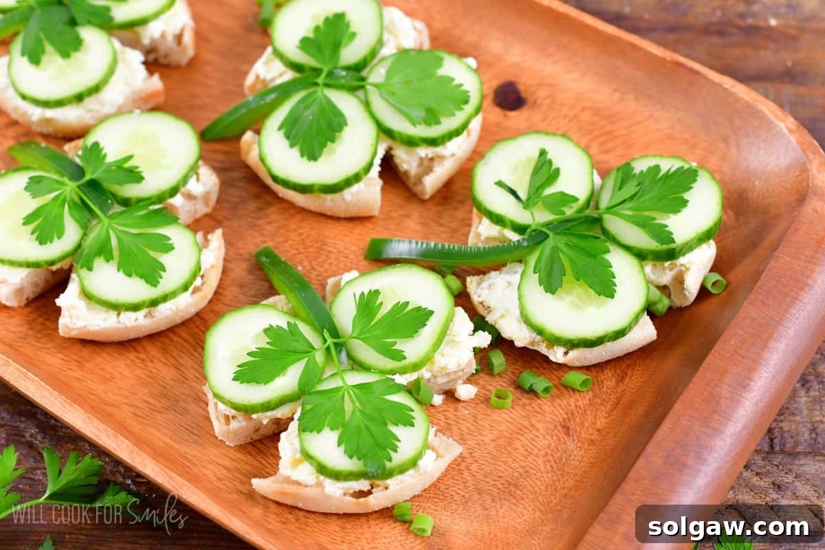 shamrock sandwhiches on a wood tray with green onions as garnish.