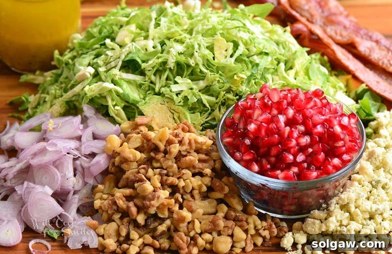 Fresh, vibrant ingredients for a Brussels sprouts salad laid out on a rustic wood cutting board, showcasing vivid colors and diverse textures before preparation.