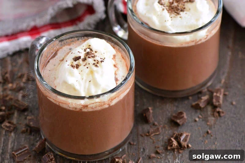 hot chocolate horizontal in glass mugs on a wood cutting board