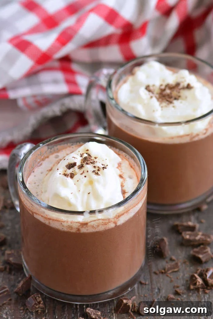 hot chocolate horizontal in glass mugs on a wood cutting board