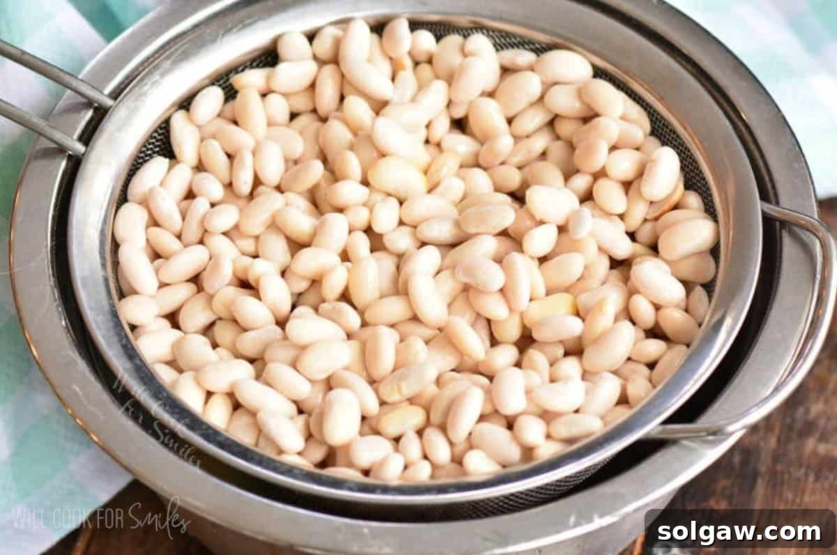 straining soaked white beans in the mesh strainer.