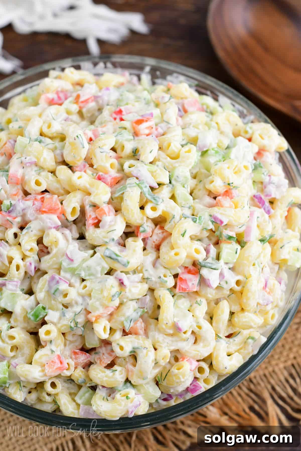 Homestyle Macaroni Salad 2 Creamy, classic macaroni salad in a large serving bowl, garnished with fresh herbs, ready for a summer picnic or BBQ.