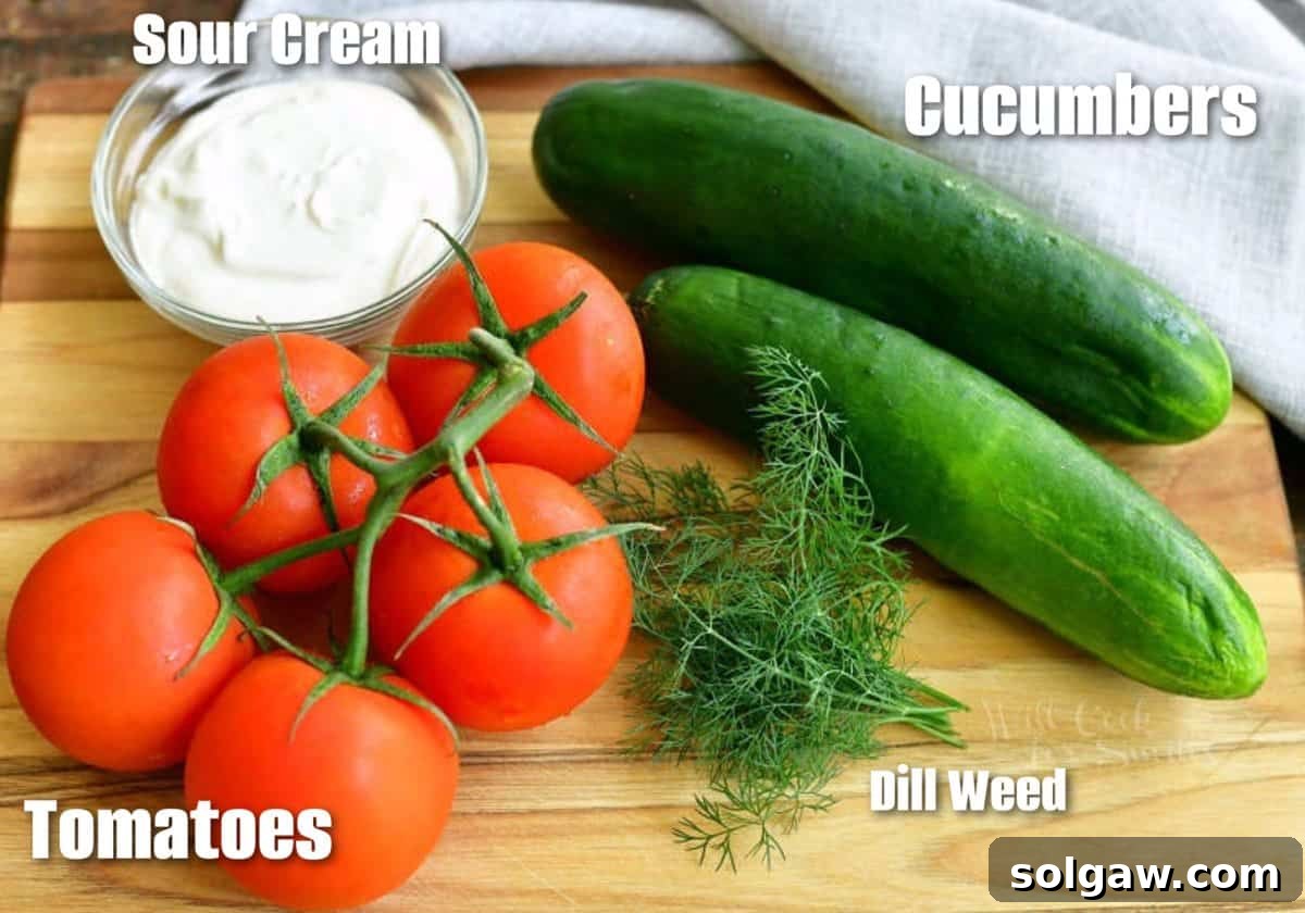 Summer Creamy Cucumber Tomato Salad 3 labeled ingredients for cucumber tomato salad on cutting board.
