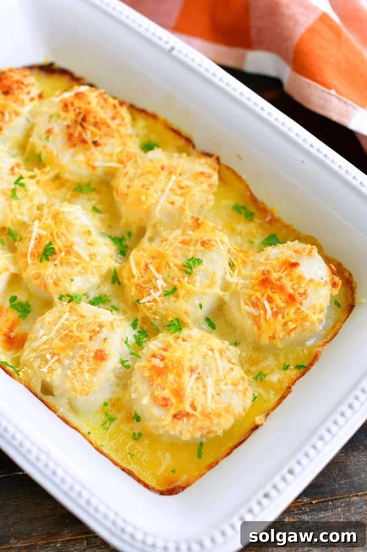 baked scallops topped with parmesan and cooked in butter in the baking dish.