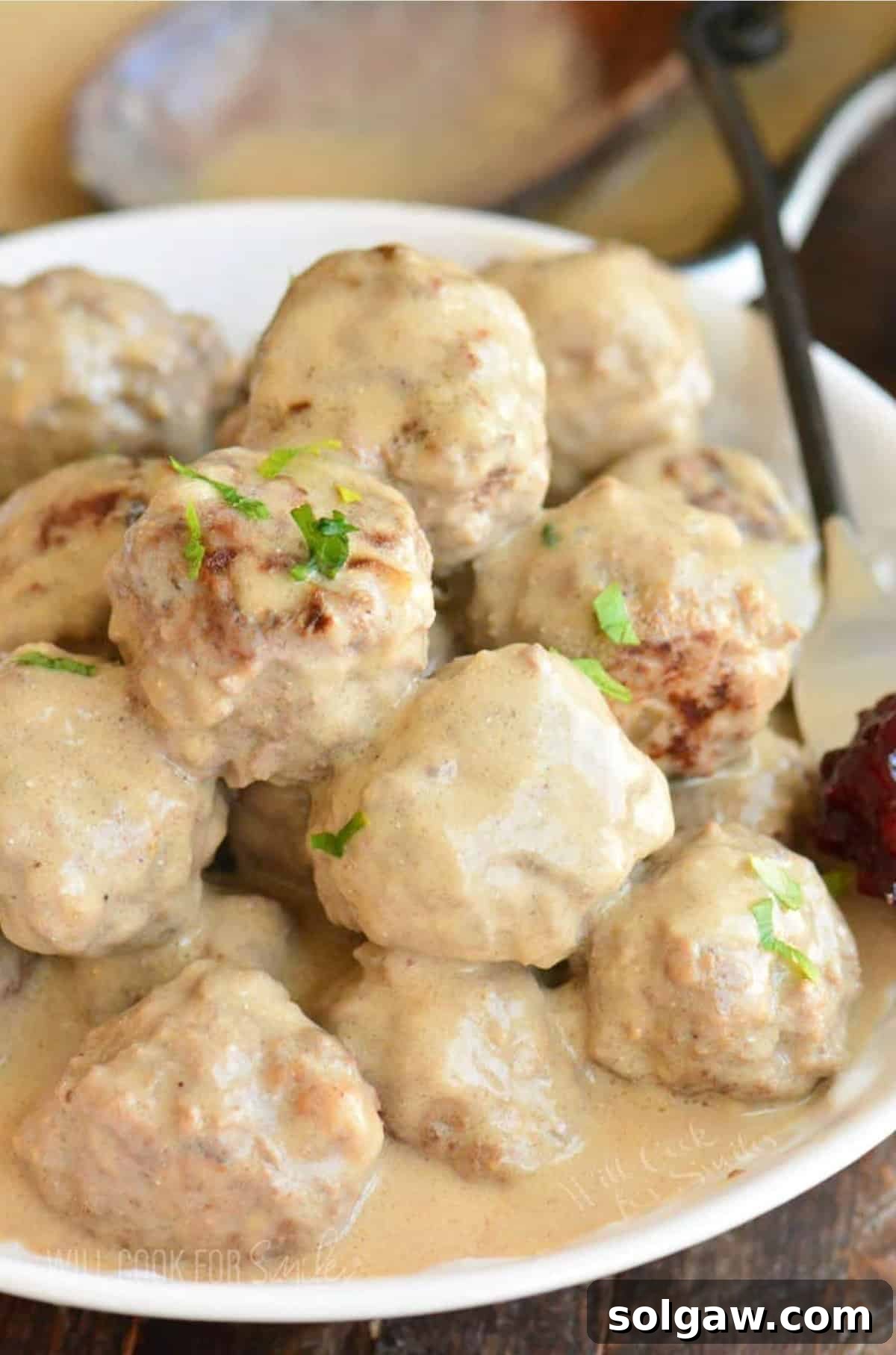 Creamy Swedish Meatballs 2 A generous mound of perfectly browned Swedish meatballs generously smothered with a rich, creamy brown gravy, ready to be served.