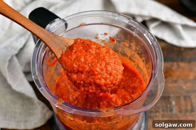 photo shows how to make pizza sauce by pureeing tomatoes in food processor