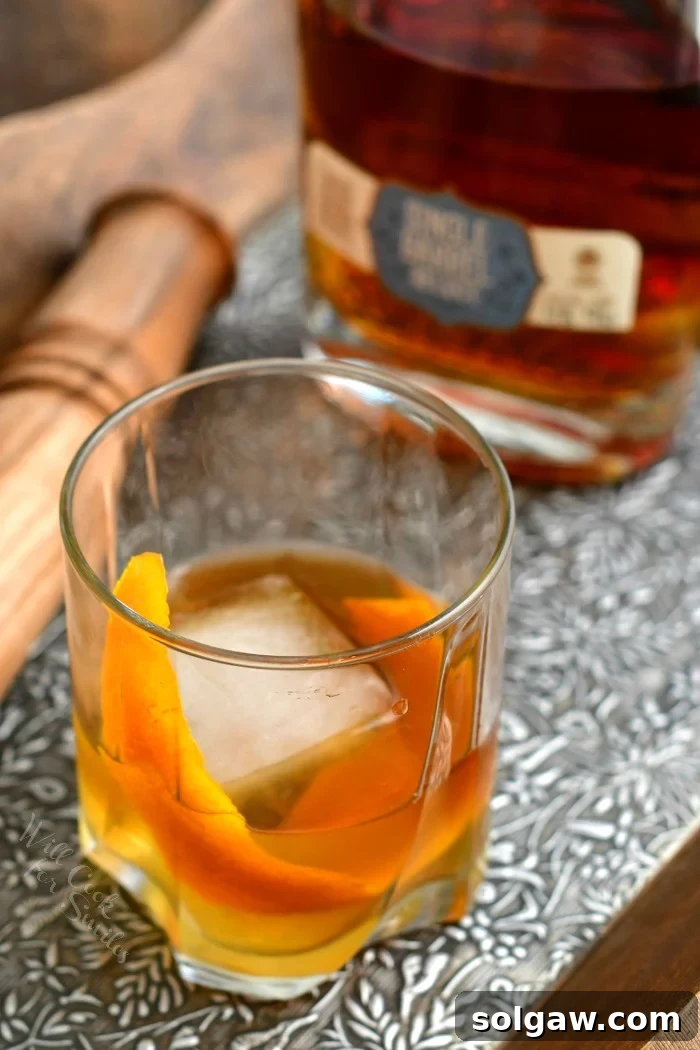 overhead photo of a bourbon Old Fashioned on the rocks with orange peel