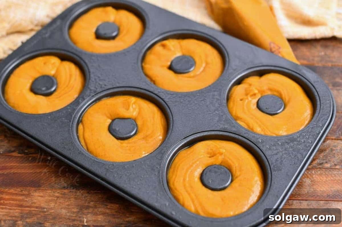 Homemade Pumpkin Spice Latte Donuts 6 Donut pan filled with raw pumpkin donut batter, ready for baking.