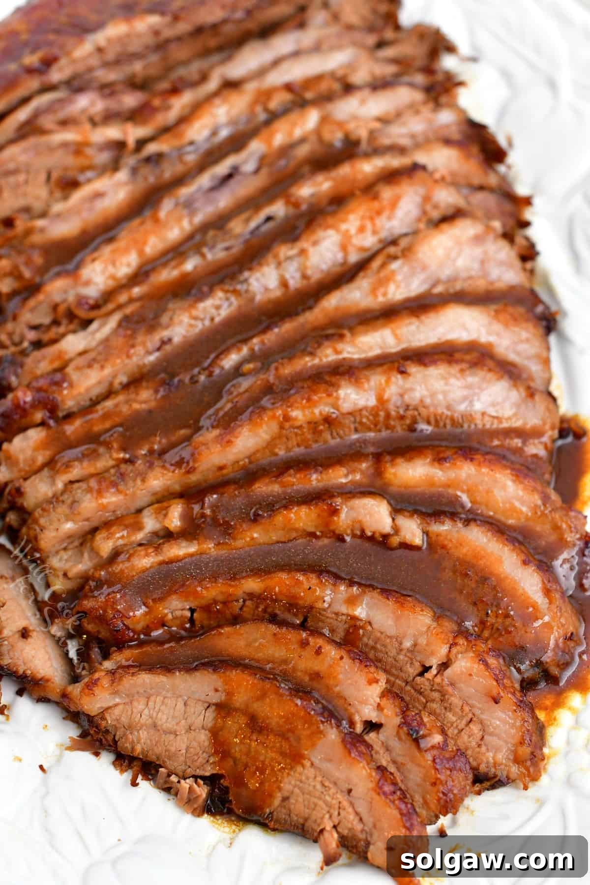 Exquisitely baked brisket slices generously covered with a rich balsamic sauce, ready to be served