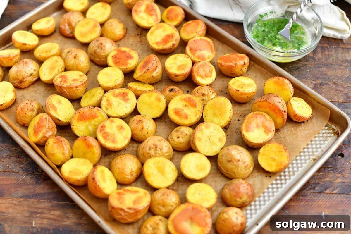 A baking sheet filled with golden roasted potatoes, perfectly crispy and ready for the finishing touches.