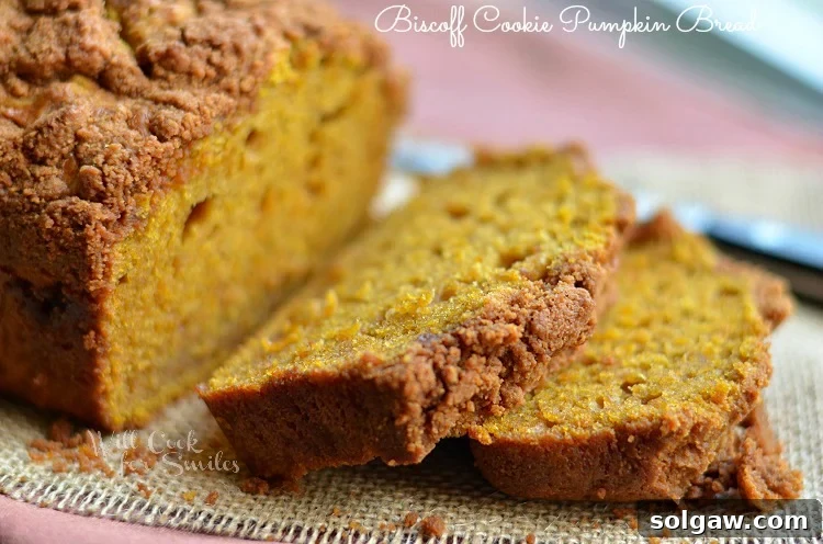 Sliced Biscoff Cookie Pumpkin Bread on a cutting board, showing moist interior