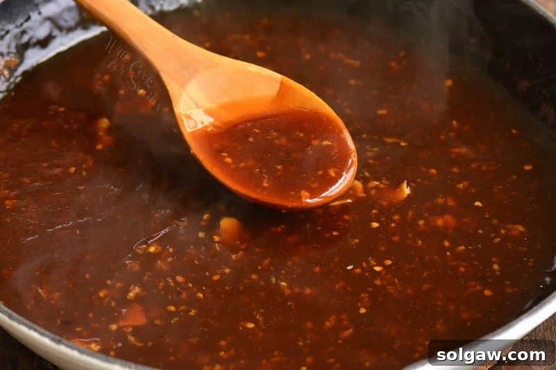 bourbon chicken sauce simmering in a pan