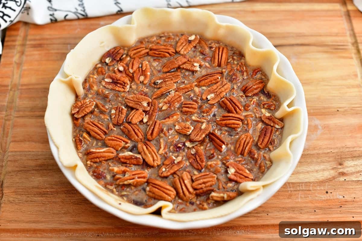 A chocolate bourbon pecan pie, unbaked and ready to go into the oven.