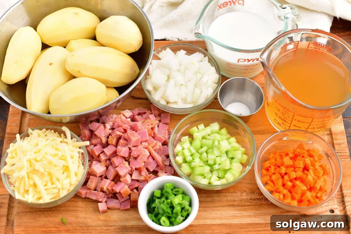 Prepared ingredients, including diced onions, carrots, celery, ham, and potatoes, neatly arranged on a cutting board.