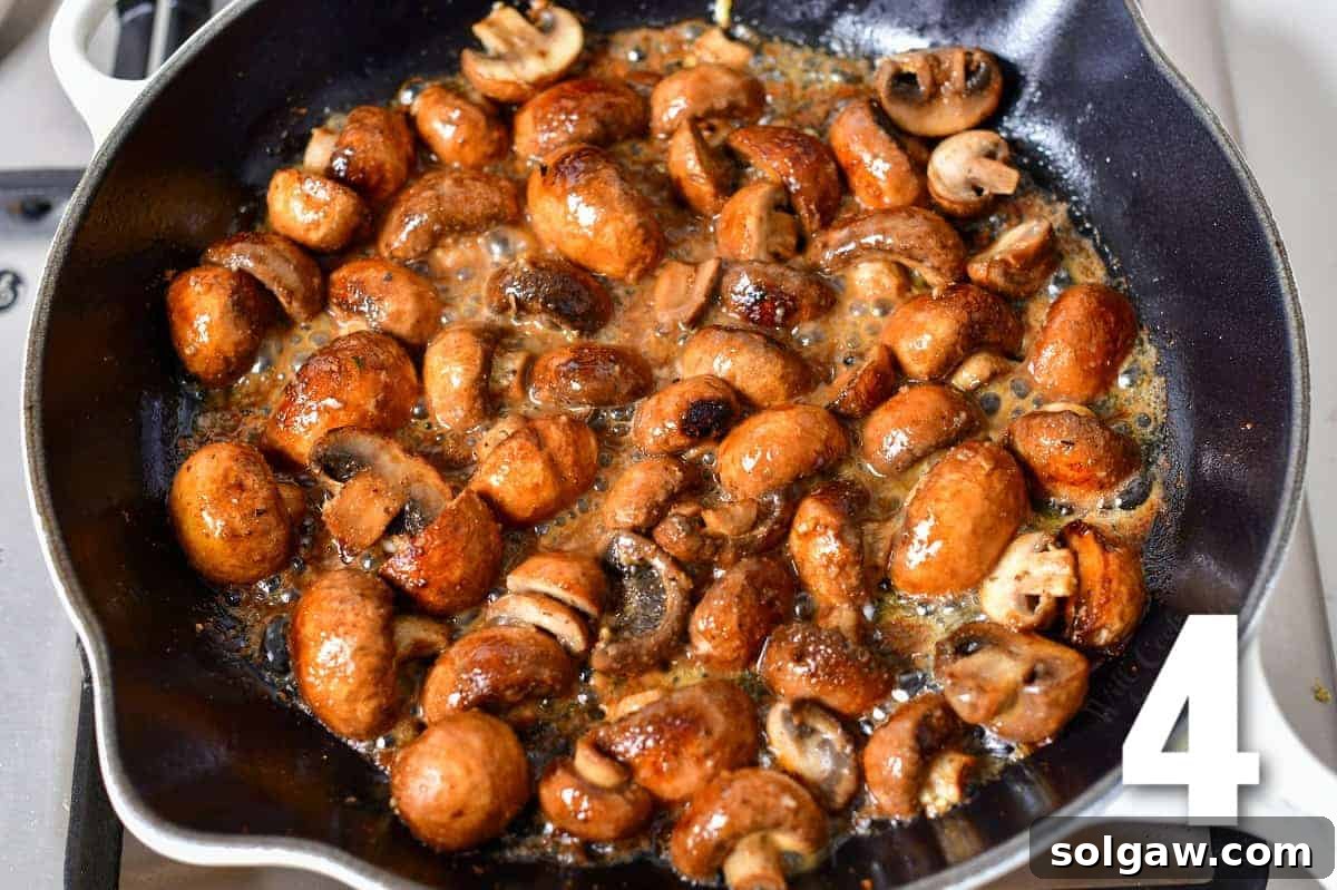Mushrooms sautéing in butter in a hot skillet, developing a golden crust