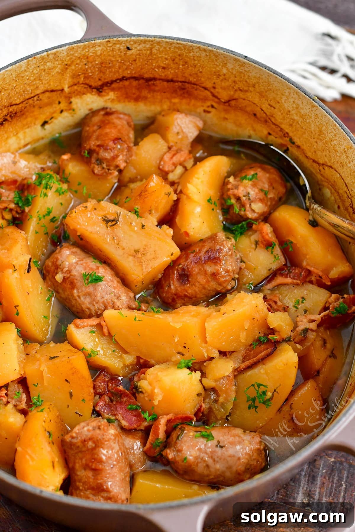 Dublin Coddle: Classic Irish Sausage and Potato Stew 9 A large Dutch oven, filled with the finished Dublin Coddle, waits to be served, a large spoon resting invitingly in the hearty mixture.