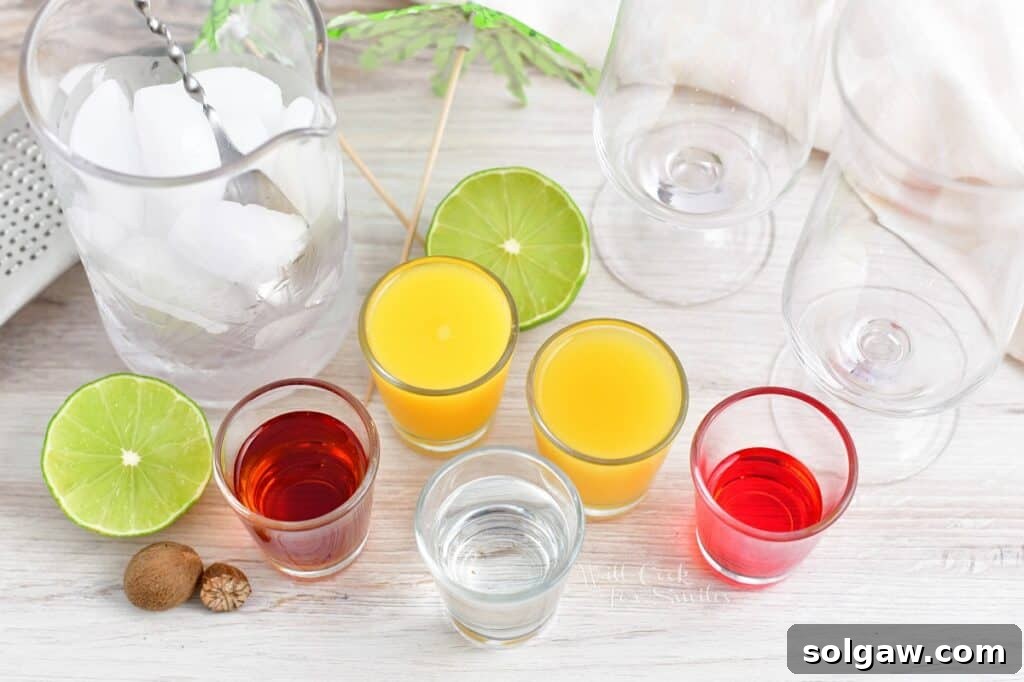 Tropical Rum Bliss 3 The vibrant ingredients for rum punch are neatly arranged on a pristine white surface, ready for mixing.