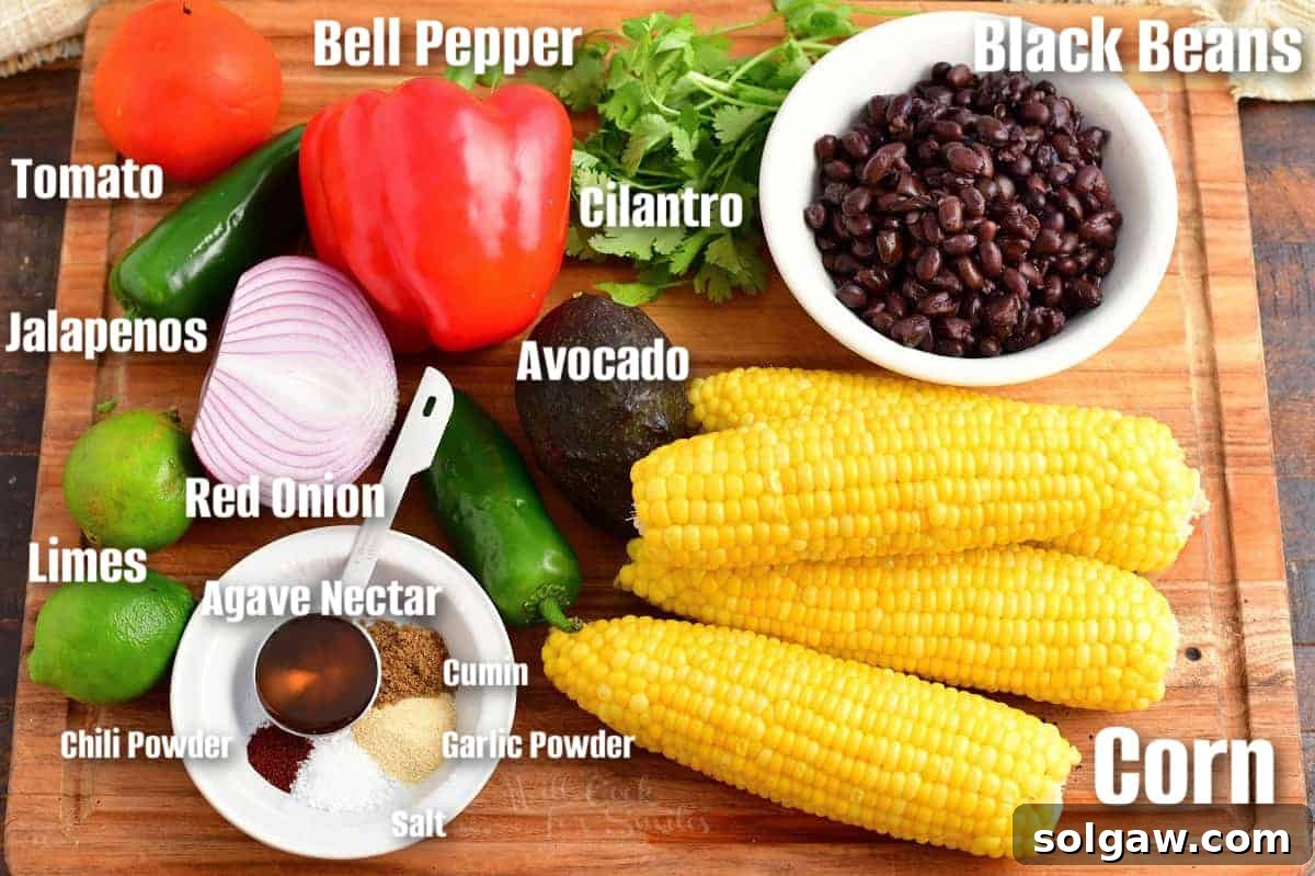 Labeled ingredients for black bean and corn salad are on a wooden surface.
