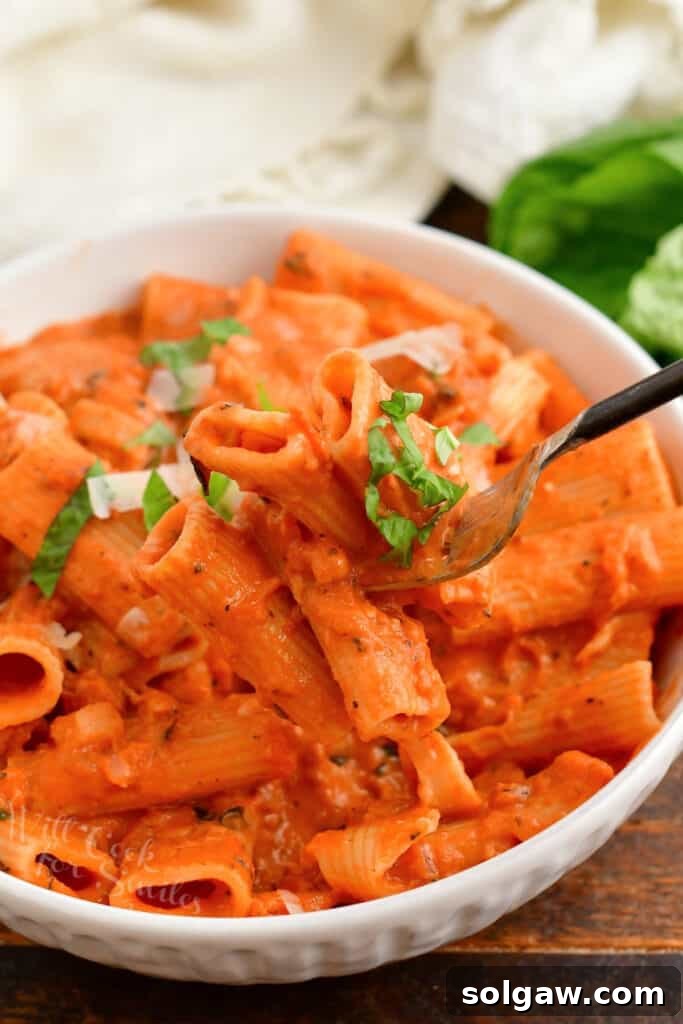 Creamy Tomato Vodka Penne 2 A fork is lifting a bite of penne alla vodka from the bowl.