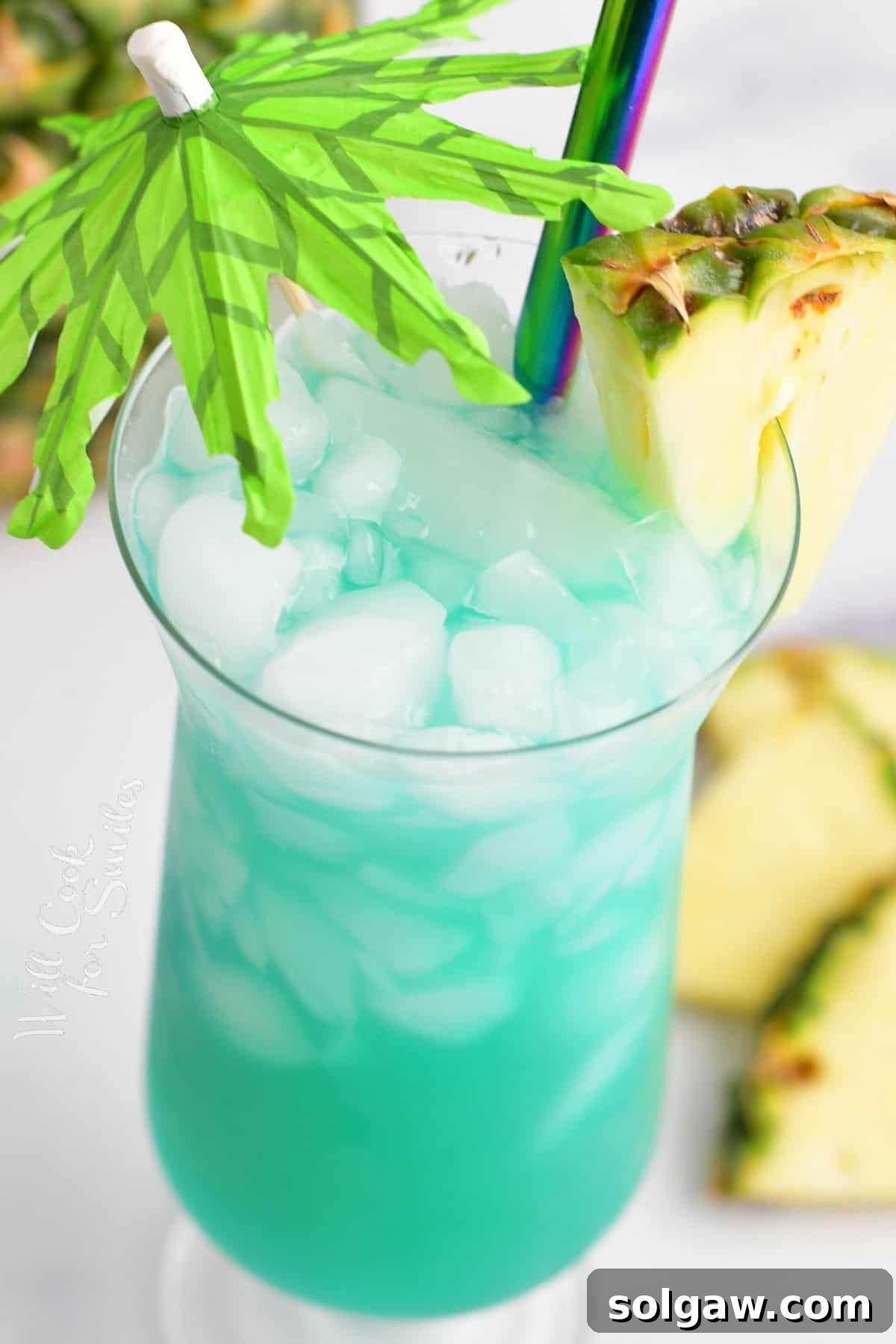 Closeup view of Blue Hawaii cocktail in a glass with an umbrella