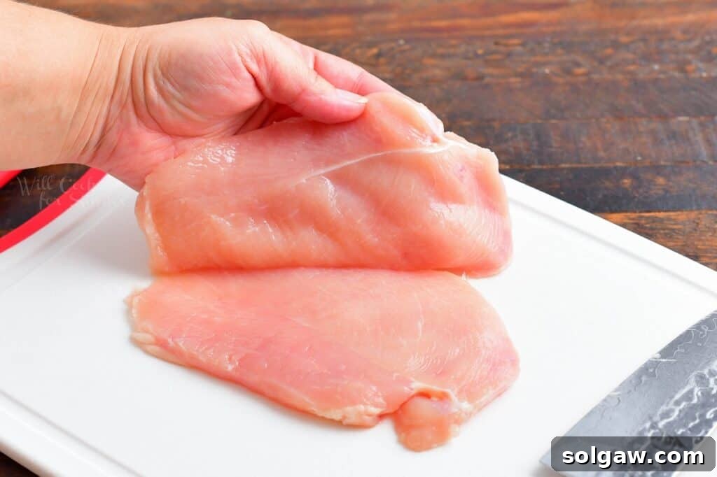 A chicken breast has been sliced in half.