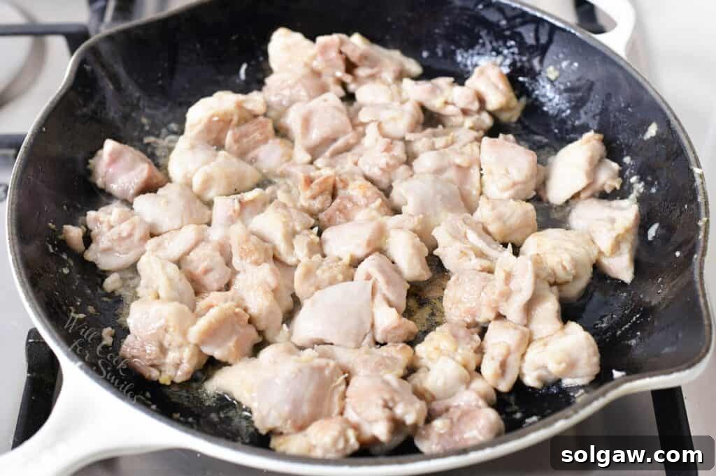 chicken thigh meat cooking in a pan