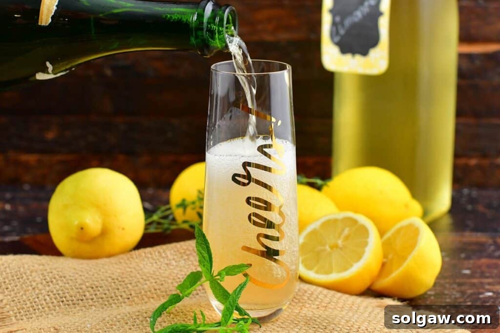 pouring in champagne into the tall glass with limoncello