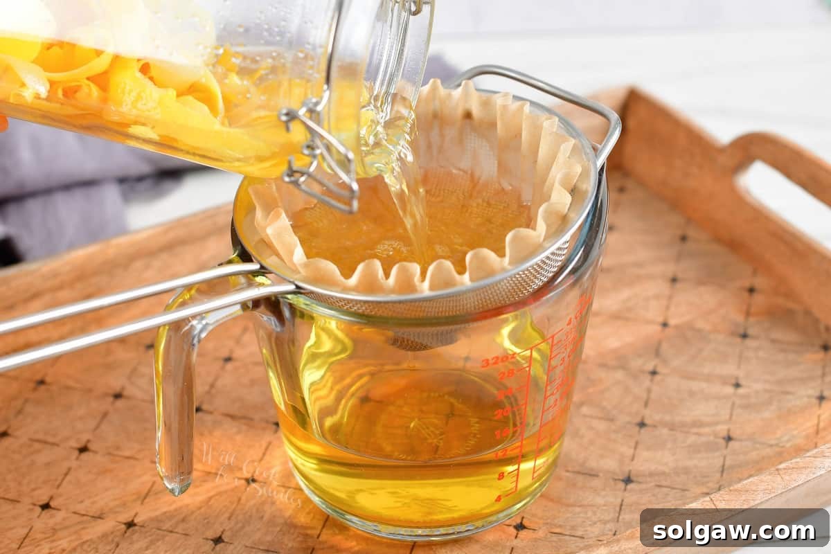 The lemon infused vodka is being strained.