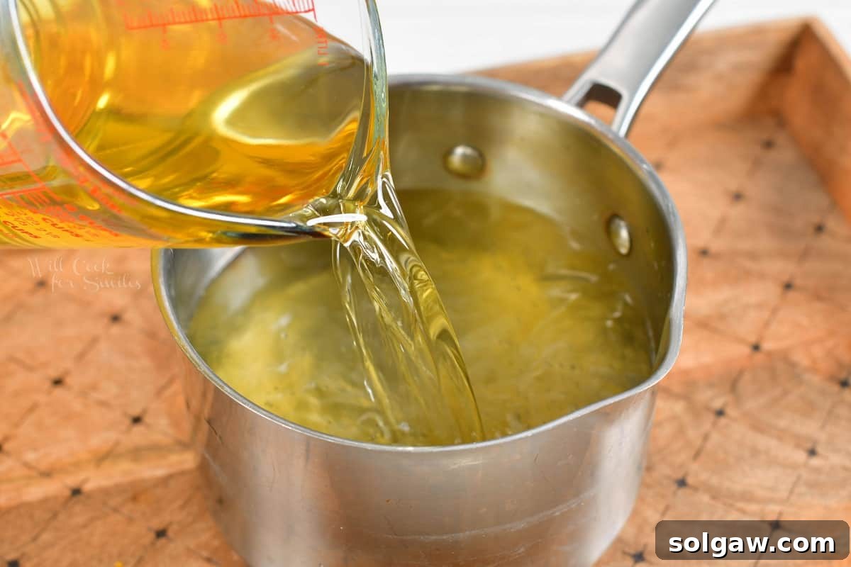 The lemon vodka is being poured into a pot.