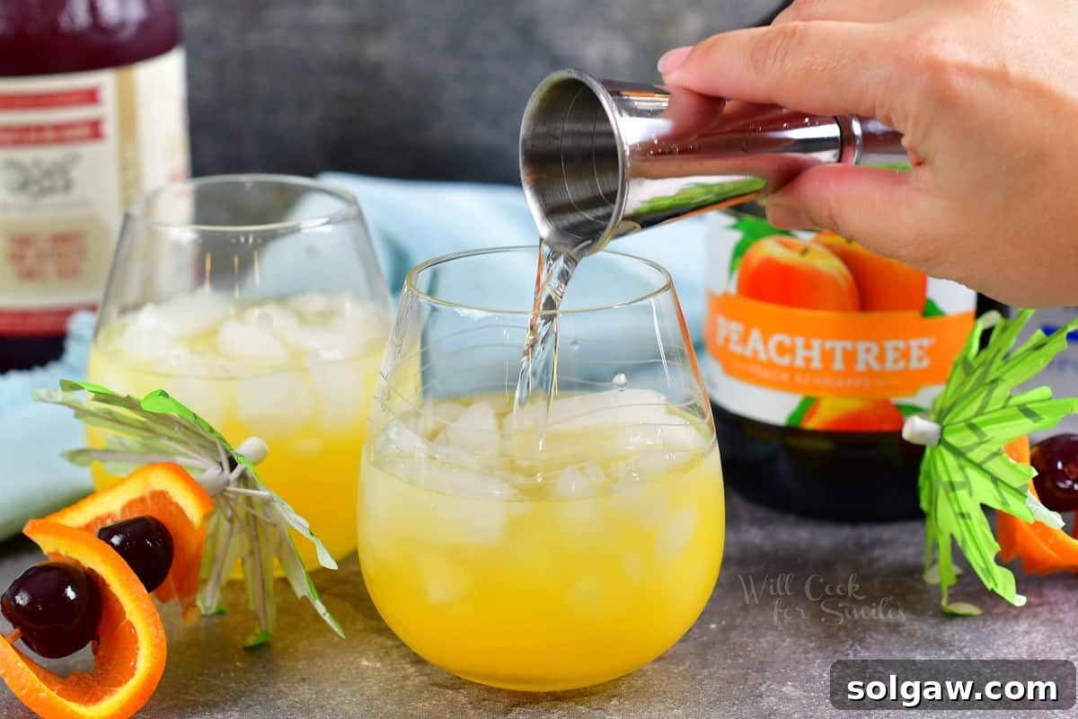 Peach schnapps adds its signature sweetness as it's poured into the mixing glass, complementing the citrus base.