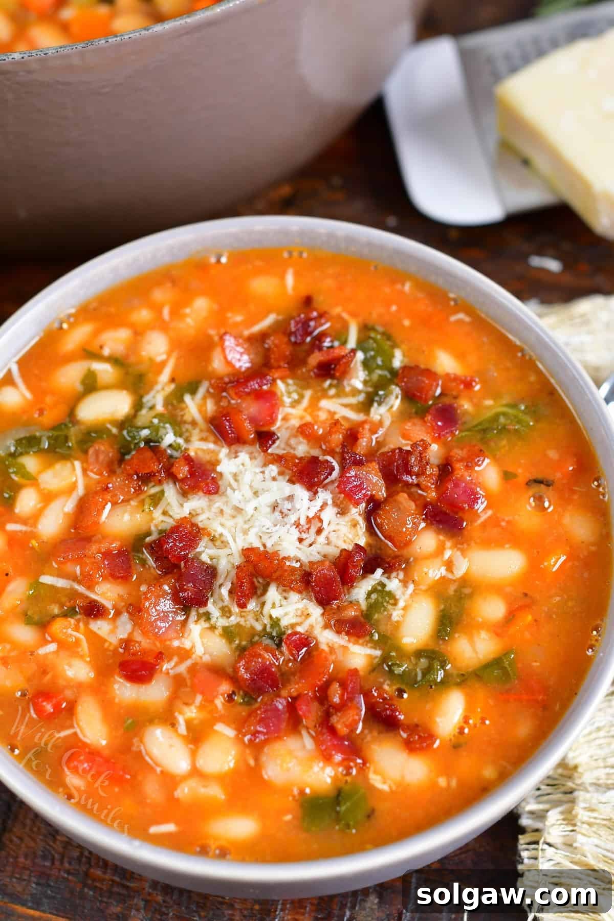 A bowl of soup is garnished and ready to eat.