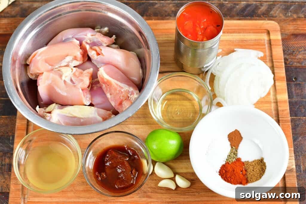 ingredients for the shredded chicken tacos on a cutting board