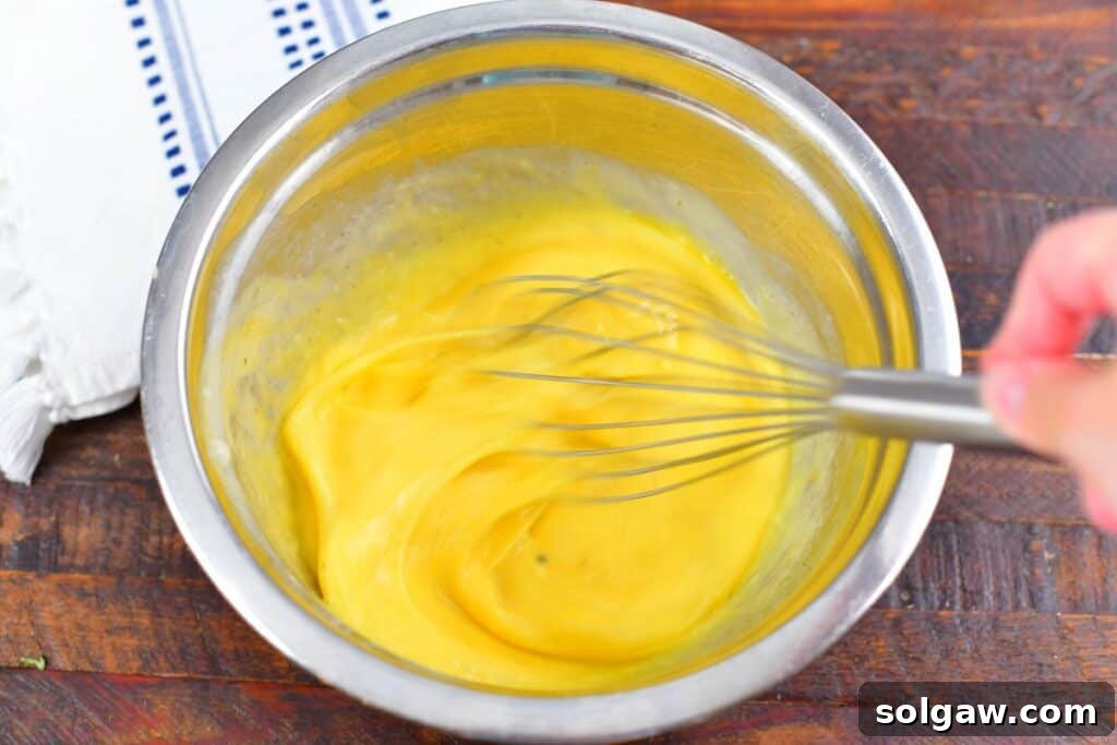 Simple Skillet Frittata 7 whisking eggs in a metal bowl