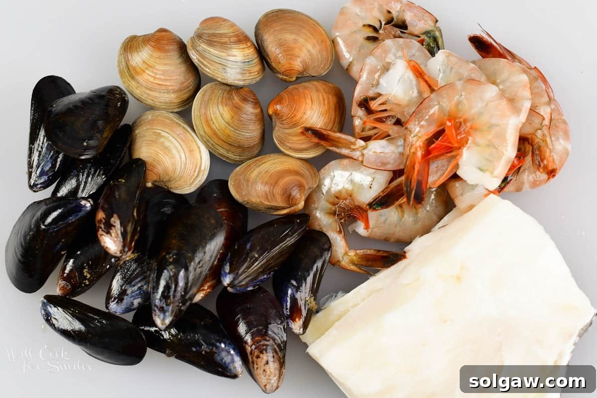 seafood for Cioppino including white fish, clams, mussels, and shrimp