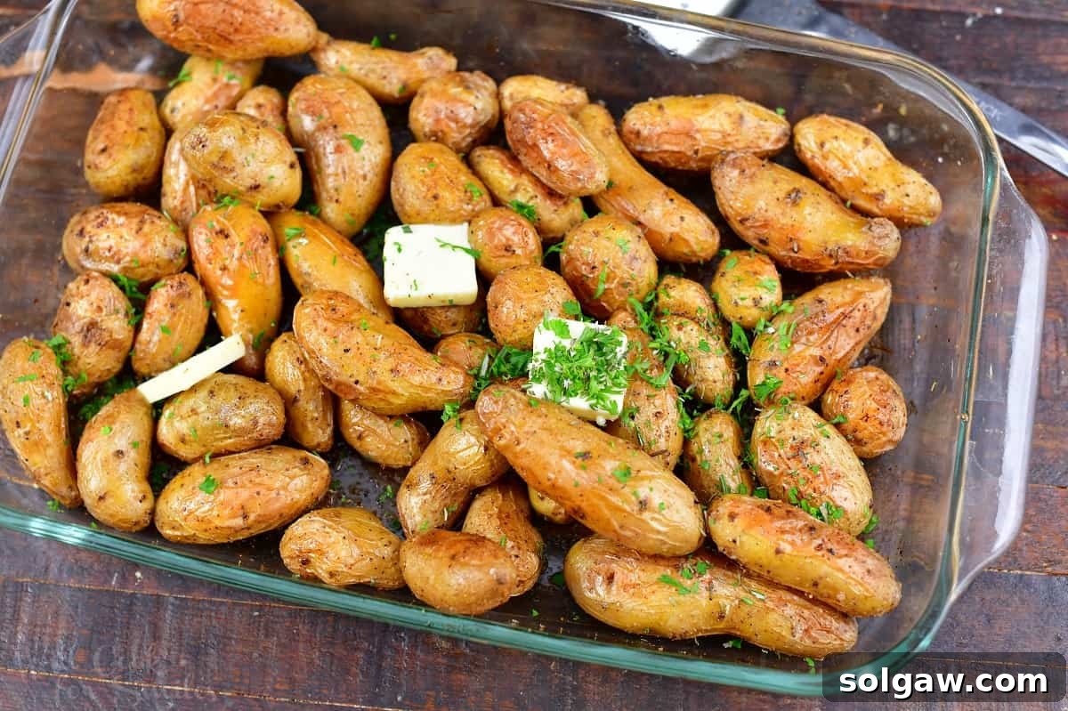 Crispy Golden Fingerling Potatoes 6 Roasted fingerling potatoes served in a glass roasting pan, glistening with melted butter and fresh herbs