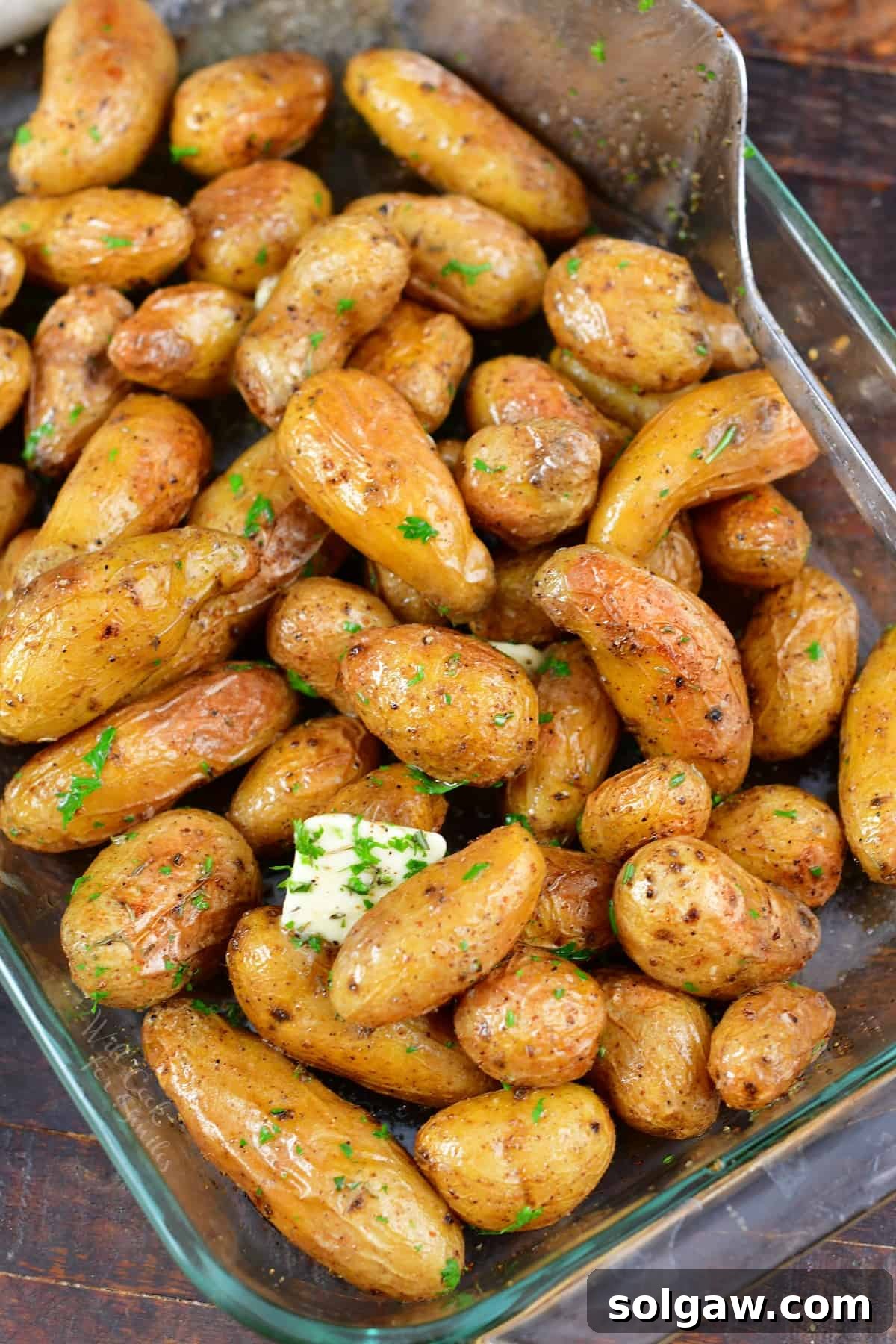 Crispy Golden Fingerling Potatoes 7 Top view of a generous serving of roasted fingerling potatoes in a baking dish, perfectly browned and seasoned