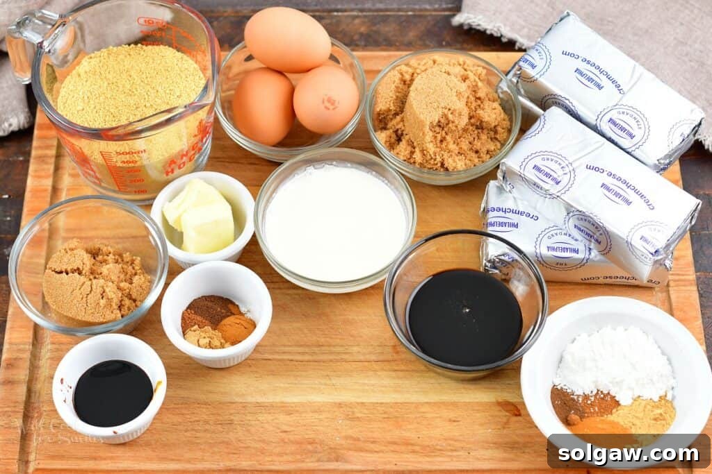 A visual display of all the key ingredients laid out on a wooden cutting board, essential for making the gingerbread cheesecake, including spices, cream cheese, molasses, and graham cracker crumbs.