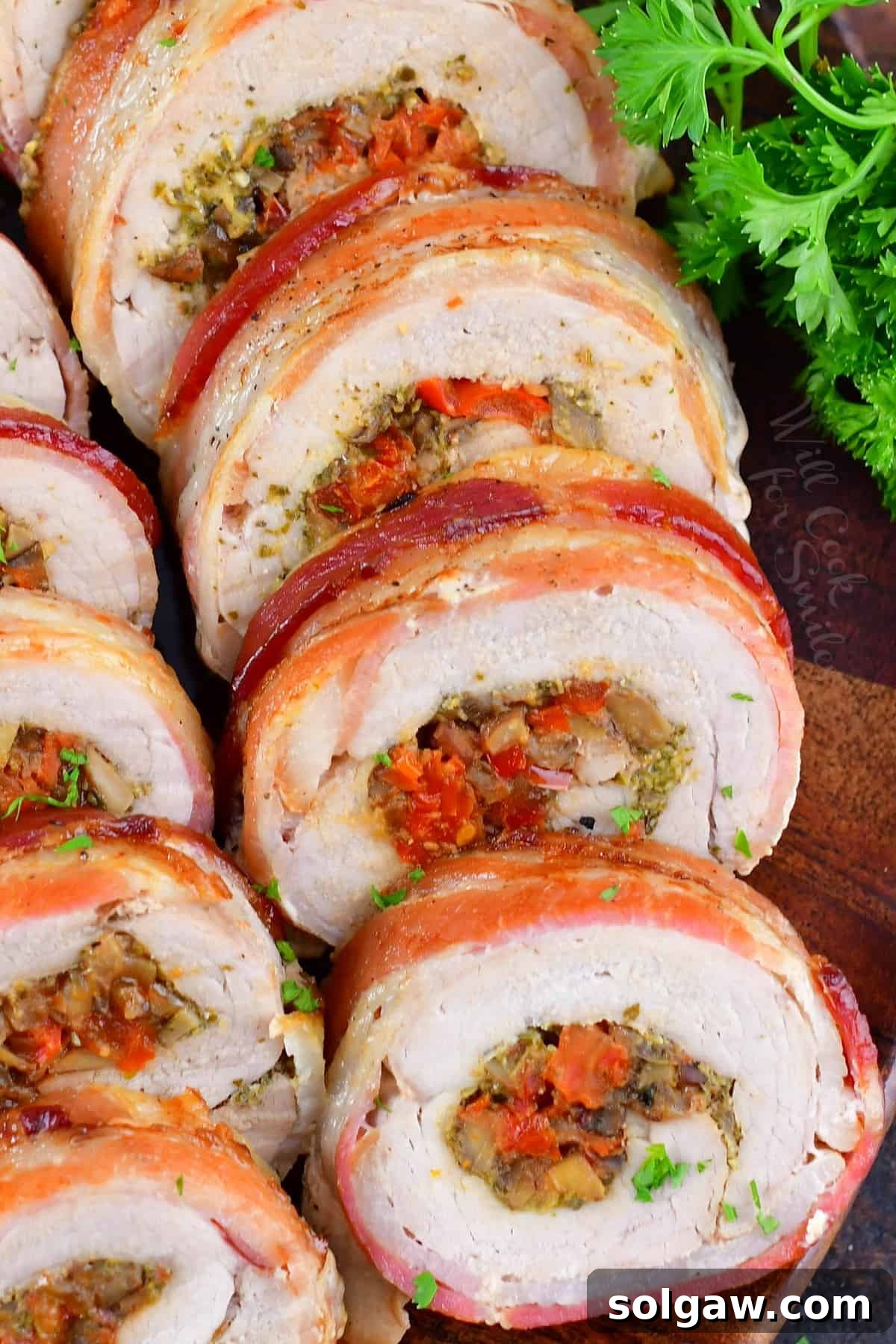 closeup of sliced stuffed pork tenderloin on a platter