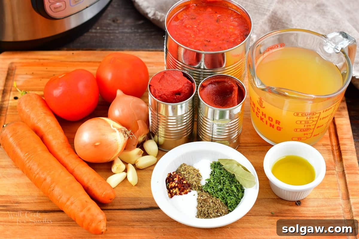 Fresh ingredients for the spaghetti sauce laid out on a wooden board: onions, carrots, tomatoes, garlic, and herbs.