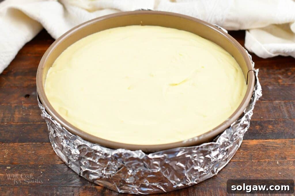 Unbaked ricotta cheesecake in a springform pan, ready for the water bath and oven.