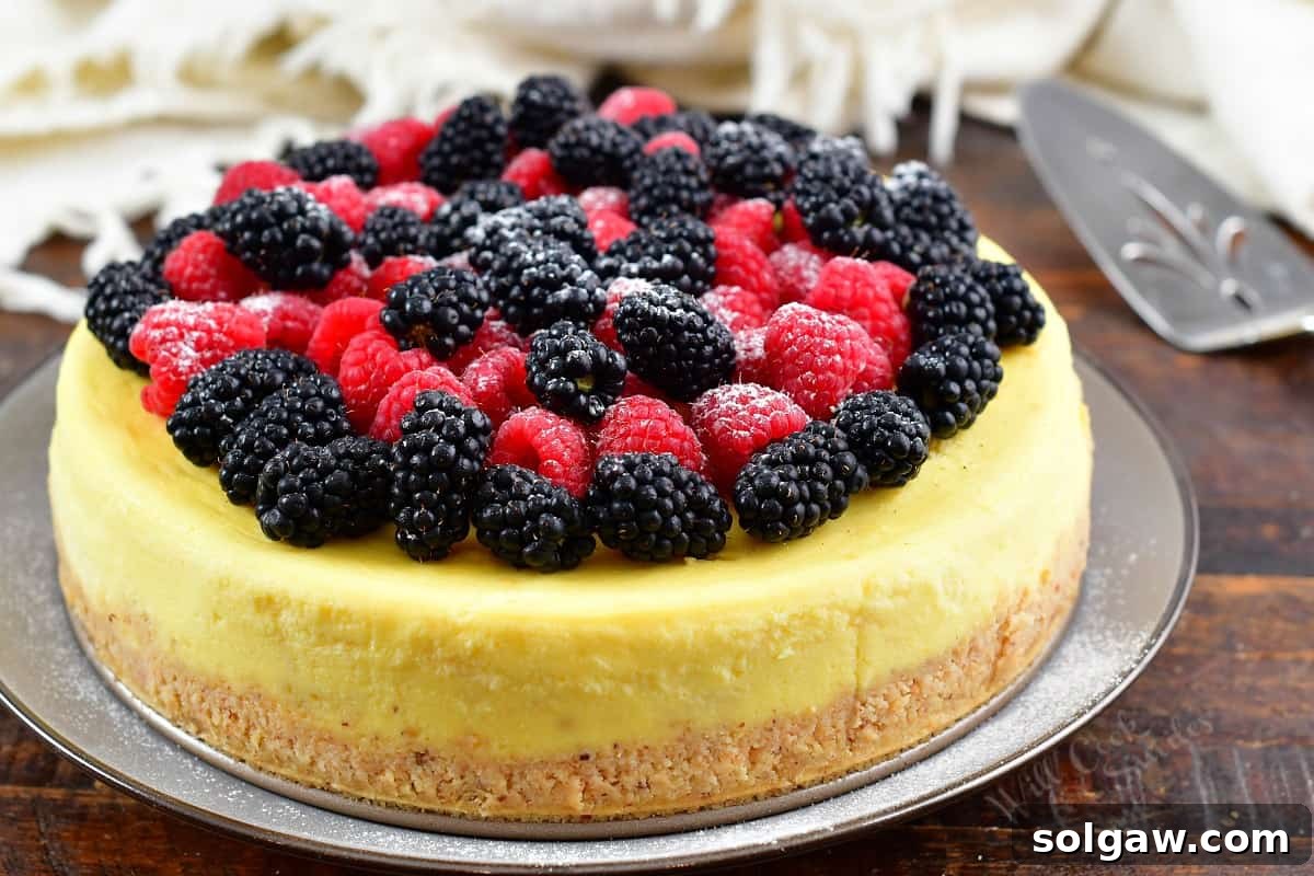 A beautifully decorated whole ricotta cheesecake, ready to be sliced and served.