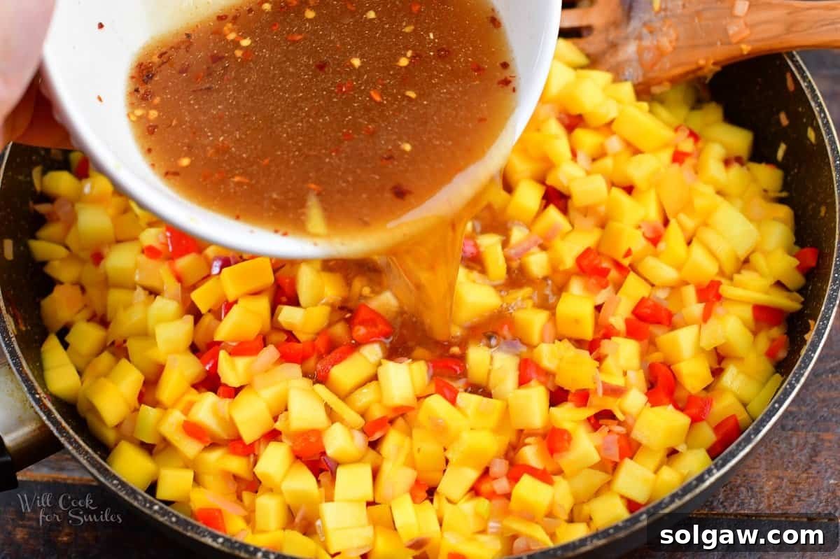 adding liquids to the mango and peppers