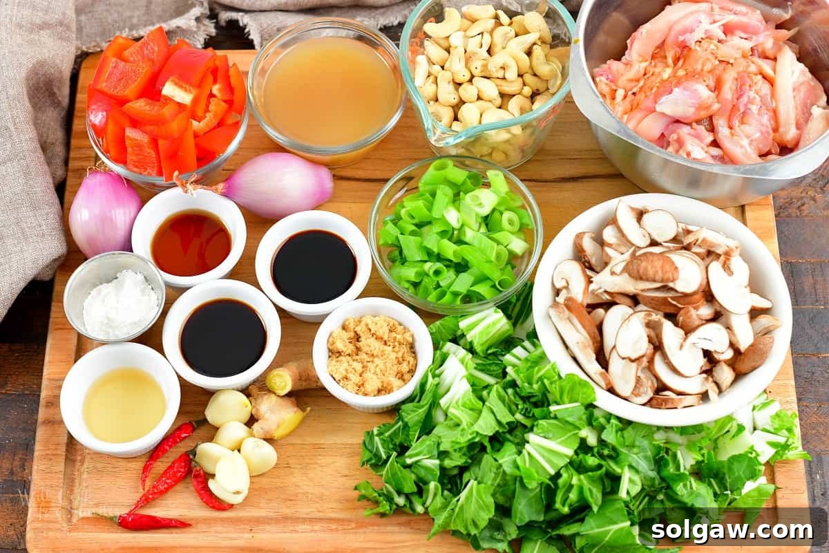 Close-up of fresh, raw ingredients including chicken, cashews, and vegetables, ready for Thai Cashew Chicken stir-fry