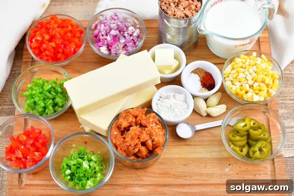 A collection of fresh ingredients laid out on a table, ready to make the ultimate queso dip.