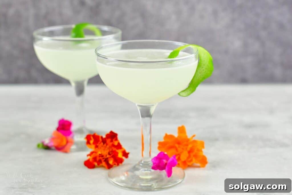 two champagne glasses with daiquiri and flowers around